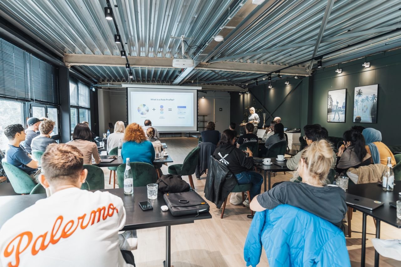 Crafting Captivating Headlines: Your awesome post title goes here A diverse group attending an educational workshop indoors, focused on a presentation.